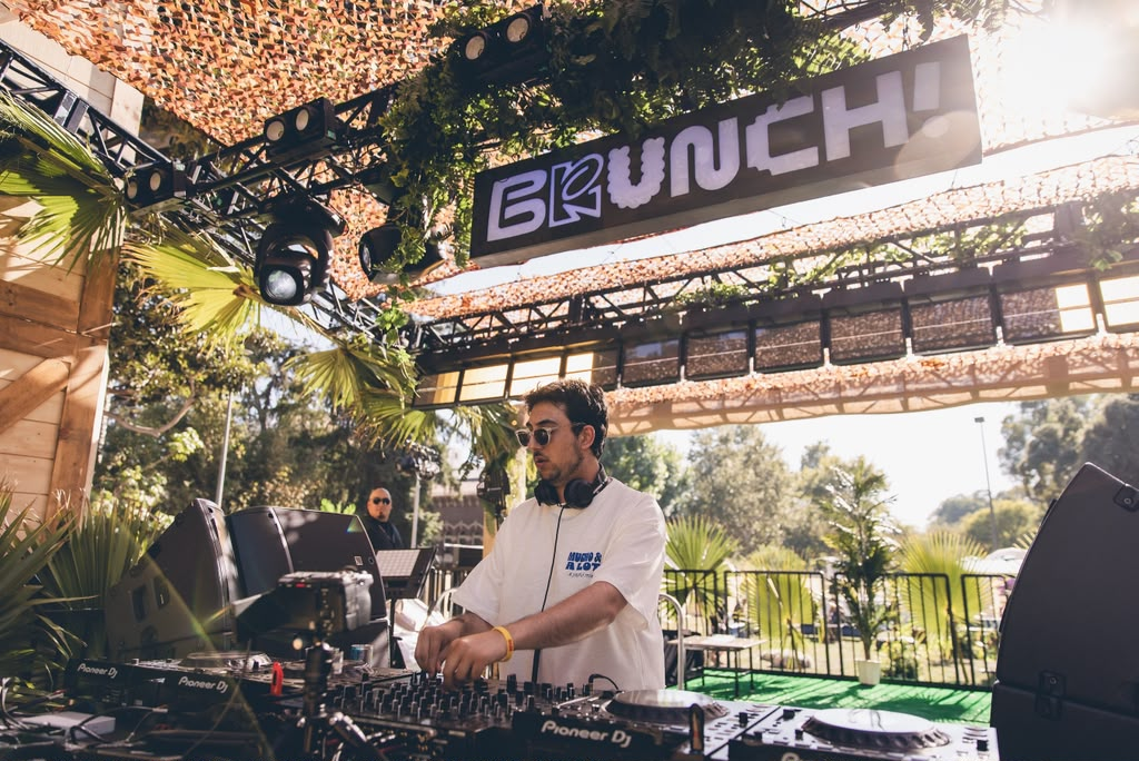 Andrew Aoun DJing under the BRUNCH! stage at an outdoor festival