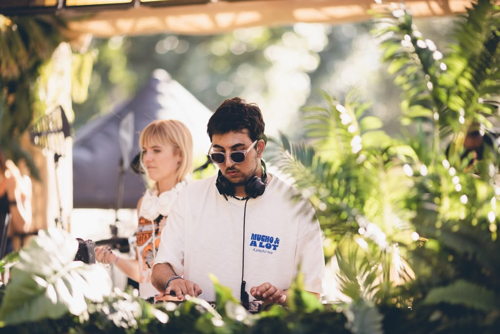 Andrew Aoun playing a daytime set surrounded by tropical greenery