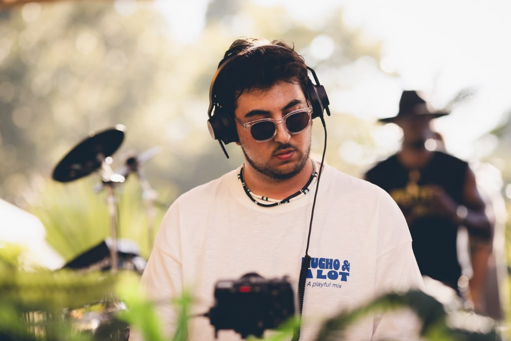 Close-up of Andrew Aoun mixing with headphones during a live set